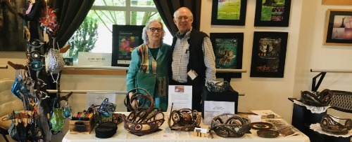 Member Seevers and guest behind artistic baskets